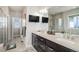 Double vanity bathroom with dual sinks and a glass shower at 7692 Weaver Cir, Castle Rock, CO 80104