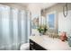 Bright bathroom with a shower-tub combo and a sink with decorative decor and a lovely painting at 7692 Weaver Cir, Castle Rock, CO 80104
