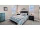 Cozy bedroom with calming decor, a comfortable bed, and natural light from large windows at 7692 Weaver Cir, Castle Rock, CO 80104