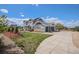 Attractive two-story home with a spacious driveway, well-maintained lawn, and lush landscaping under sunny skies at 7692 Weaver Cir, Castle Rock, CO 80104