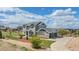 Charming exterior view with a three-car garage and lovely landscaping at 7692 Weaver Cir, Castle Rock, CO 80104