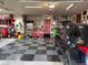Spacious garage featuring checkered flooring, ample storage, and a red door for added character at 7692 Weaver Cir, Castle Rock, CO 80104