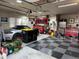 Spacious garage featuring a checkered floor, car, and mechanic's tool storage at 7692 Weaver Cir, Castle Rock, CO 80104