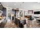 Gourmet kitchen open to living room with fireplace, island seating at 7692 Weaver Cir, Castle Rock, CO 80104