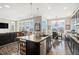 Modern kitchen features an island, open to dining, and living areas at 7692 Weaver Cir, Castle Rock, CO 80104