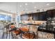 Modern kitchen features a large island with breakfast bar at 7692 Weaver Cir, Castle Rock, CO 80104
