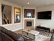 Comfortable living room with a fireplace and stairs access at 7692 Weaver Cir, Castle Rock, CO 80104