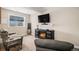 Cozy living room with a fireplace, mounted TV, comfortable seating, and soft natural light at 7692 Weaver Cir, Castle Rock, CO 80104