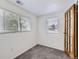 Bright bedroom featuring two windows, white walls, and carpeted floors at 4730 S Huron St, Englewood, CO 80110