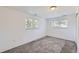 Bright bedroom with neutral carpet, crisp white walls, and windows providing ample natural light at 4730 S Huron St, Englewood, CO 80110