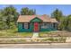 Charming home with a red front door and well-maintained green exterior at 4730 S Huron St, Englewood, CO 80110