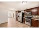 Open kitchen layout featuring stainless steel appliances and ample cabinet space at 4730 S Huron St, Englewood, CO 80110