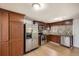 Modern kitchen with stainless steel appliances, dark wood cabinets, and a mosaic backsplash at 4730 S Huron St, Englewood, CO 80110