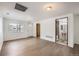 Bright living room with wood floors and open access to the bathroom and front door at 4730 S Huron St, Englewood, CO 80110