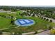 Overhead shot of tennis courts and a neighborhood, highlighting community recreation at 7038 Russell Ct, Arvada, CO 80007