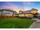 Well-manicured backyard with a spacious lawn and inviting dark wood deck, ideal for outdoor enjoyment at 7038 Russell Ct, Arvada, CO 80007