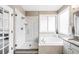Modern bathroom with a glass-enclosed shower, soaking tub, and elegant fixtures at 7038 Russell Ct, Arvada, CO 80007