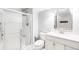 Modern bathroom features a glass-enclosed shower and a vanity with a sink, offering a clean and functional design at 7038 Russell Ct, Arvada, CO 80007