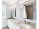 Spacious bathroom with a dual vanity, granite countertops, and a tiled shower at 7038 Russell Ct, Arvada, CO 80007