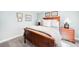Inviting bedroom with a wooden bed frame, decorative pillows, and matching nightstands for a comfortable retreat at 7038 Russell Ct, Arvada, CO 80007