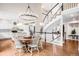 Elegant dining area and kitchen featuring a grand staircase, an open layout and hardwood flooring at 7038 Russell Ct, Arvada, CO 80007