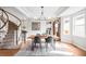 Inviting dining room with a wooden table, modern lighting, and a unique spiral staircase nearby at 7038 Russell Ct, Arvada, CO 80007