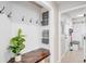 Inviting entryway with bench, coat hooks, and storage for a practical and stylish home organization solution at 7038 Russell Ct, Arvada, CO 80007