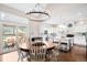 Open concept kitchen featuring a center island, white cabinets, stainless appliances, and a large dining area at 7038 Russell Ct, Arvada, CO 80007