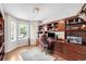 Stylish home office with custom built-ins, hardwood floors, and ample natural light at 7038 Russell Ct, Arvada, CO 80007