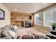 Comfortable living room with rustic wood accent wall and fireplace at 15675 E Kettle Pl, Centennial, CO 80112