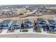 An aerial view shows the property and the community in a neighborhood setting with mountain views at 490 Silver Rock Trl, Castle Rock, CO 80104