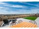 Outdoor living with a concrete patio featuring a fire pit, dining set, and scenic backyard views at 490 Silver Rock Trl, Castle Rock, CO 80104
