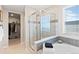 This luxurious bathroom offers a shower, tub, and walk-in closet at 490 Silver Rock Trl, Castle Rock, CO 80104