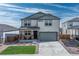 Two-story home with a two-car garage, covered front porch, and a well-maintained lawn against a bright sky at 490 Silver Rock Trl, Castle Rock, CO 80104
