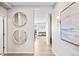 Bright foyer featuring wood floors, round mirrors, and an open view to other rooms at 490 Silver Rock Trl, Castle Rock, CO 80104