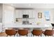 Modern kitchen with a spacious island, bar seating, and sleek stainless steel appliances at 490 Silver Rock Trl, Castle Rock, CO 80104
