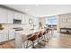 Open-concept kitchen with bar seating, modern appliances, and a seamless flow into the dining area at 490 Silver Rock Trl, Castle Rock, CO 80104