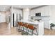 Spacious kitchen with a large island, stainless steel appliances, and stylish chevron backsplash at 490 Silver Rock Trl, Castle Rock, CO 80104