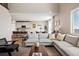 Bright, open-concept living room with a kitchen and dining area, featuring a large couch, and stylish decor at 490 Silver Rock Trl, Castle Rock, CO 80104