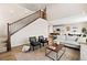 Open-concept living space features a staircase with wooden banisters and a view of the kitchen and dining area at 490 Silver Rock Trl, Castle Rock, CO 80104