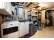 Unfinished basement laundry area with washer and dryer and storage shelves at 10890 Willow Reed West Cir, Parker, CO 80134