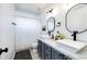 A modern bathroom featuring a dual sink vanity with updated fixtures and stylish mirrors at 10890 Willow Reed West Cir, Parker, CO 80134