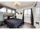 A stylish bedroom with a wood accent wall, decorative shelves, and natural light from a window at 10890 Willow Reed West Cir, Parker, CO 80134