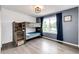 A charming bedroom featuring a wooden bunk bed and a bright window with blue curtains at 10890 Willow Reed West Cir, Parker, CO 80134