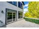 Exterior view of deck with black trimmed windows and slider and a leafy green divider wall at 10890 Willow Reed West Cir, Parker, CO 80134