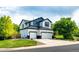 Two-story home boasts a two-car garage, manicured lawn, and a classic exterior paint scheme at 10890 Willow Reed West Cir, Parker, CO 80134