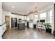 Bright kitchen with stainless steel appliances, granite countertops, gray island, and an adjacent home office space at 10890 Willow Reed West Cir, Parker, CO 80134