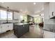 Open-concept kitchen and living room with granite counters, an island, and natural light at 10890 Willow Reed West Cir, Parker, CO 80134