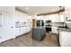Modern kitchen with white cabinets, gray island, stainless steel appliances, and granite countertops at 10890 Willow Reed West Cir, Parker, CO 80134
