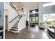 Open-concept living area with high ceilings, hardwood floors, fireplace and large windows providing natural light at 10890 Willow Reed West Cir, Parker, CO 80134